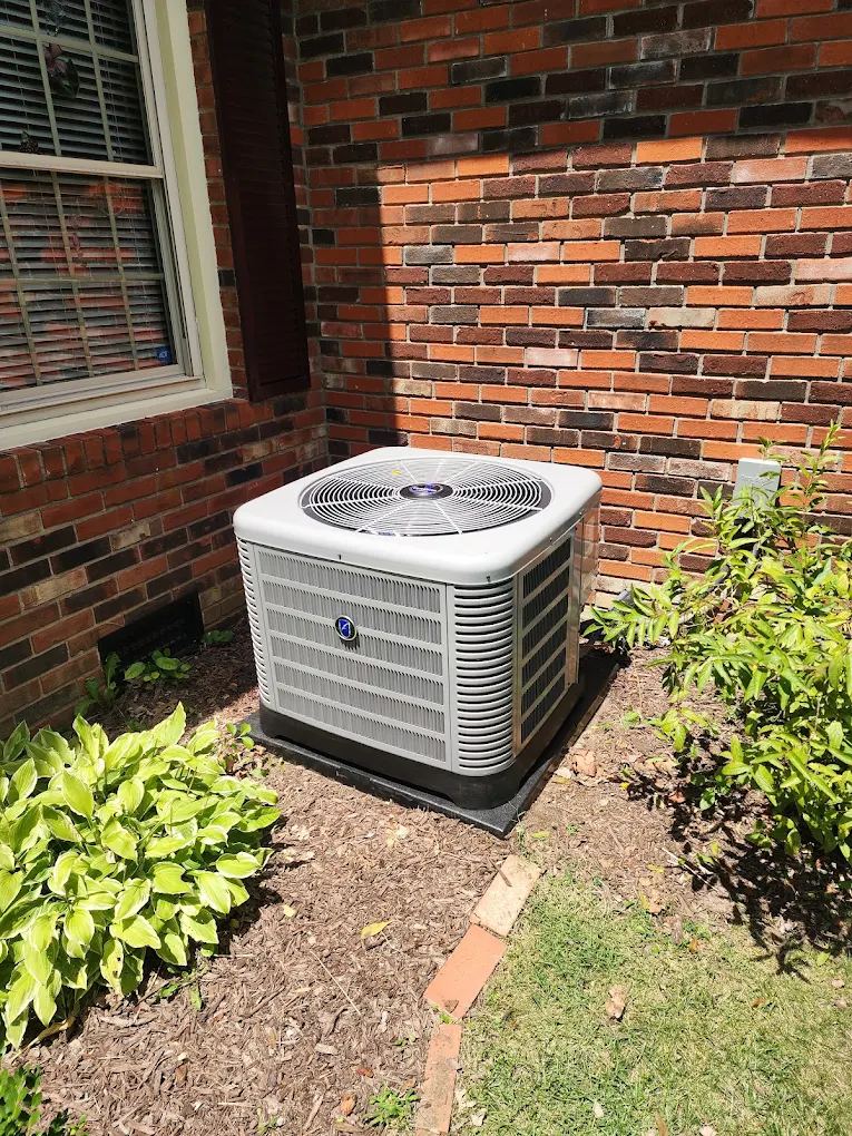 New air conditioner condenser installed at a brick home