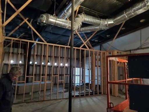 Commercial ductwork installed overhead during a JHC Services buildout