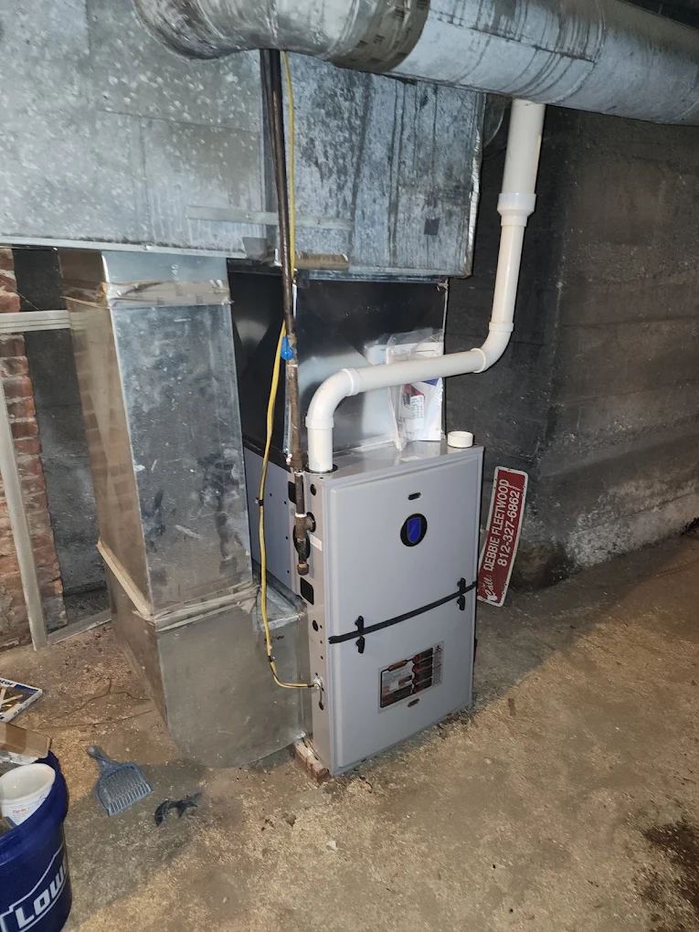 High-efficiency furnace with PVC venting installed in an older stone basement