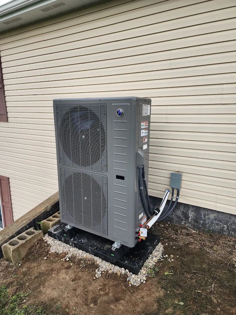 Variable-speed heat pump on a leveled pad at a sided home