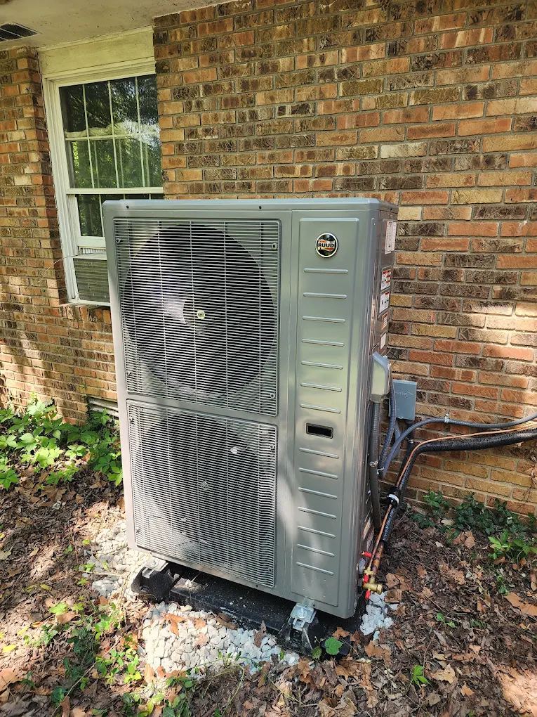 Ruud side-discharge heat pump installed at a brick home